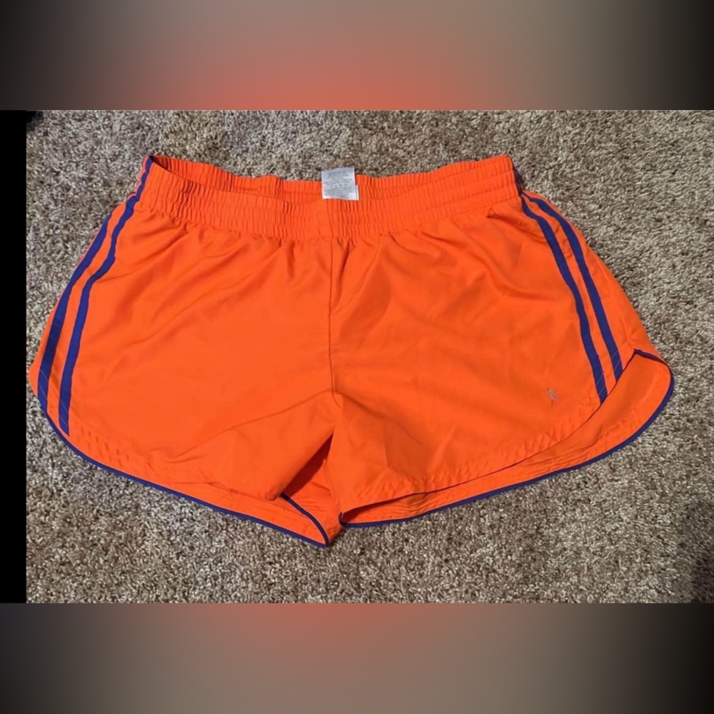 Orange with purple ish/ blue stripe down the side. Athletic shorts.